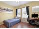 Bedroom with a twin-size bed, wood desk, yellow walls, a ceiling fan, and natural light at 18726 E Yale Cir # F, Aurora, CO 80013