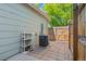 This backyard patio features an air conditioner, small shelving, and a wood fence at 1918 Depew St, Lakewood, CO 80214
