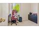 Bedroom features a window, carpet flooring, and desk with modern gaming chair at 1918 Depew St, Lakewood, CO 80214