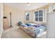 Cozy bedroom with neutral carpet and multiple windows, offering ample natural light at 1918 Depew St, Lakewood, CO 80214