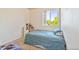 Bedroom with carpet flooring and window, featuring a blue patterned bed at 1918 Depew St, Lakewood, CO 80214