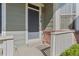 Close-up of the front door with a concrete step, white picket railing and brick facade at 1918 Depew St, Lakewood, CO 80214