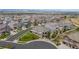 An aerial view displays a well-planned community with tree-lined streets and mountain views, showcasing the neighborhood at 15994 La Plata Peak Pl, Broomfield, CO 80023