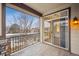 A cozy balcony with wrought iron railings and a sliding glass door offers a view of the neighborhood at 11391 Navajo Cir # B, Westminster, CO 80234