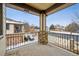 An angled view of the balcony showing stone supports and wrought iron railings, with a neighborhood view at 11391 Navajo Cir # B, Westminster, CO 80234
