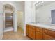 Bathroom featuring a single sink vanity, a large mirror, and a walk-in shower at 11391 Navajo Cir # B, Denver, CO 80234