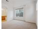 Bright bedroom featuring a large window offering natural light, with an ensuite bathroom entrance at 11391 Navajo Cir # B, Westminster, CO 80234