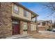 A two-story townhouse with a red front door, stone accents, and a second-story balcony at 11391 Navajo Cir # B, Westminster, CO 80234