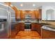Stylish kitchen featuring stainless steel appliances, dark granite countertops, and wood flooring at 11391 Navajo Cir # B, Westminster, CO 80234