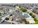 A view of the community pool with covered surface surrounded by apartments, trees and parking at 10381 Cook Way # 202, Thornton, CO 80229