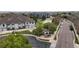 Overhead shot of community buildings, well-maintained lawns, mature trees, community signage and street access at 10381 Cook Way # 202, Thornton, CO 80229