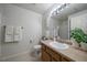 Well-lit bathroom featuring a vanity with tan countertops and a decorative green plant at 10381 Cook Way # 202, Thornton, CO 80229