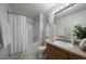 Neutral bathroom featuring a shower-tub combo and single sink vanity with ample light at 10381 Cook Way # 202, Thornton, CO 80229