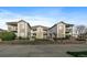 Attractive multi-Gathering home featuring a stone facade, balconies, and well-maintained landscaping at 10381 Cook Way # 202, Thornton, CO 80229