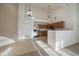 Bright, open-concept kitchen featuring stainless steel appliances and neutral carpeting at 10381 Cook Way # 202, Thornton, CO 80229