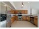Well-equipped kitchen boasting stainless steel appliances, wooden cabinetry, and ample countertop space at 10381 Cook Way # 202, Thornton, CO 80229