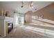 Inviting living room with a fireplace, neutral carpet, access to balcony and lots of natural light at 10381 Cook Way # 202, Thornton, CO 80229