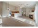 Cozy living room with vaulted ceilings, fireplace, stainless steel appliances, and neutral carpeting at 10381 Cook Way # 202, Thornton, CO 80229