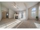 Bright living room with vaulted ceiling, fireplace, plush carpet, and sliding glass doors to a balcony at 10381 Cook Way # 202, Thornton, CO 80229