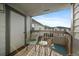 Cozy patio with two chairs, small table, and a view of the neighborhood at 10381 Cook Way # 202, Thornton, CO 80229