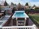 Beautiful backyard with a built-in swim spa, brick patio, and wood fencing at 8757 W 75Th Way, Arvada, CO 80005
