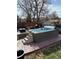 Beautiful backyard with a built-in swim spa, brick patio, and wood fencing at 8757 W 75Th Way, Arvada, CO 80005