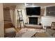 Finished basement with a fireplace, TV, and cozy seating area at 8757 W 75Th Way, Arvada, CO 80005