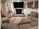 Comfortable basement living area with fireplace, mounted TV, and window at 8757 W 75Th Way, Arvada, CO 80005