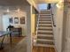 Finished basement with ping pong table and hardwood steps with black metal railing at 8757 W 75Th Way, Arvada, CO 80005
