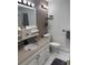 Bright bathroom featuring granite countertops, white vanity, and decorative accents at 8757 W 75Th Way, Arvada, CO 80005