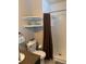 Bright bathroom featuring a shower, corner shelves, and marble countertops at 8757 W 75Th Way, Arvada, CO 80005