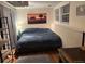Bedroom with neutral paint, large window, bed, and closet organizer at 8757 W 75Th Way, Arvada, CO 80005