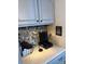 A cozy coffee station with stone backsplash and upper cabinets at 8757 W 75Th Way, Arvada, CO 80005
