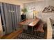 Inviting dining area features a wood table, bench, stylish lighting, and natural light from a window at 8757 W 75Th Way, Arvada, CO 80005