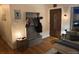 Inviting entryway with a coat rack, a charming front door, and hardwood floors at 8757 W 75Th Way, Arvada, CO 80005