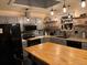 Spacious kitchen with stainless steel appliances, butcher block island, and decorative backsplash at 8757 W 75Th Way, Arvada, CO 80005