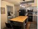 Kitchen featuring gray cabinets, a kitchen island with seating, granite countertops, and stainless steel appliances at 8757 W 75Th Way, Arvada, CO 80005