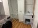 Functional laundry area with sink, modern washer, and wire shelving at 8757 W 75Th Way, Arvada, CO 80005