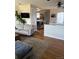 Comfortable living room featuring hardwood floors, modern decor, and seamless kitchen access at 8757 W 75Th Way, Arvada, CO 80005