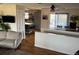 Open concept living room features a comfortable sofa, hardwood floors, and an abundance of natural light at 8757 W 75Th Way, Arvada, CO 80005