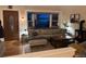 Cozy living room features a sectional sofa, a large bay window, and a charming wood-burning stove at 8757 W 75Th Way, Arvada, CO 80005