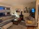Comfortable living room features a wood-burning stove, plush sectional sofa, and natural light at 8757 W 75Th Way, Arvada, CO 80005