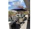 Beautiful patio seating area with umbrella and lush greenery at 8757 W 75Th Way, Arvada, CO 80005