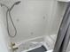Shower stall with tiled walls, bathtub, and shower head with an adjustable arm at 8757 W 75Th Way, Arvada, CO 80005