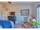 Cozy bedroom features a chair, end table, and dresser with warm decor at 494 Black Feather Loop # 117, Castle Rock, CO 80104