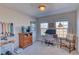 Bedroom featuring desk, chair, and large windows offering beautiful views of the city and landscape at 494 Black Feather Loop # 117, Castle Rock, CO 80104