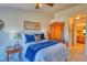 Comfortable bedroom featuring blue bedding and a large wardrobe with bathroom access at 494 Black Feather Loop # 117, Castle Rock, CO 80104