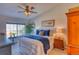 Bedroom featuring a comfortable bed, a ceiling fan, and a large window with neighborhood views at 494 Black Feather Loop # 117, Castle Rock, CO 80104