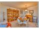 Well-lit dining area with a table, chairs, and beautiful built-in bookcases at 494 Black Feather Loop # 117, Castle Rock, CO 80104