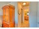 Hallway featuring a bathroom entrance with a decorative mirror and wooden dresser at 494 Black Feather Loop # 117, Castle Rock, CO 80104
